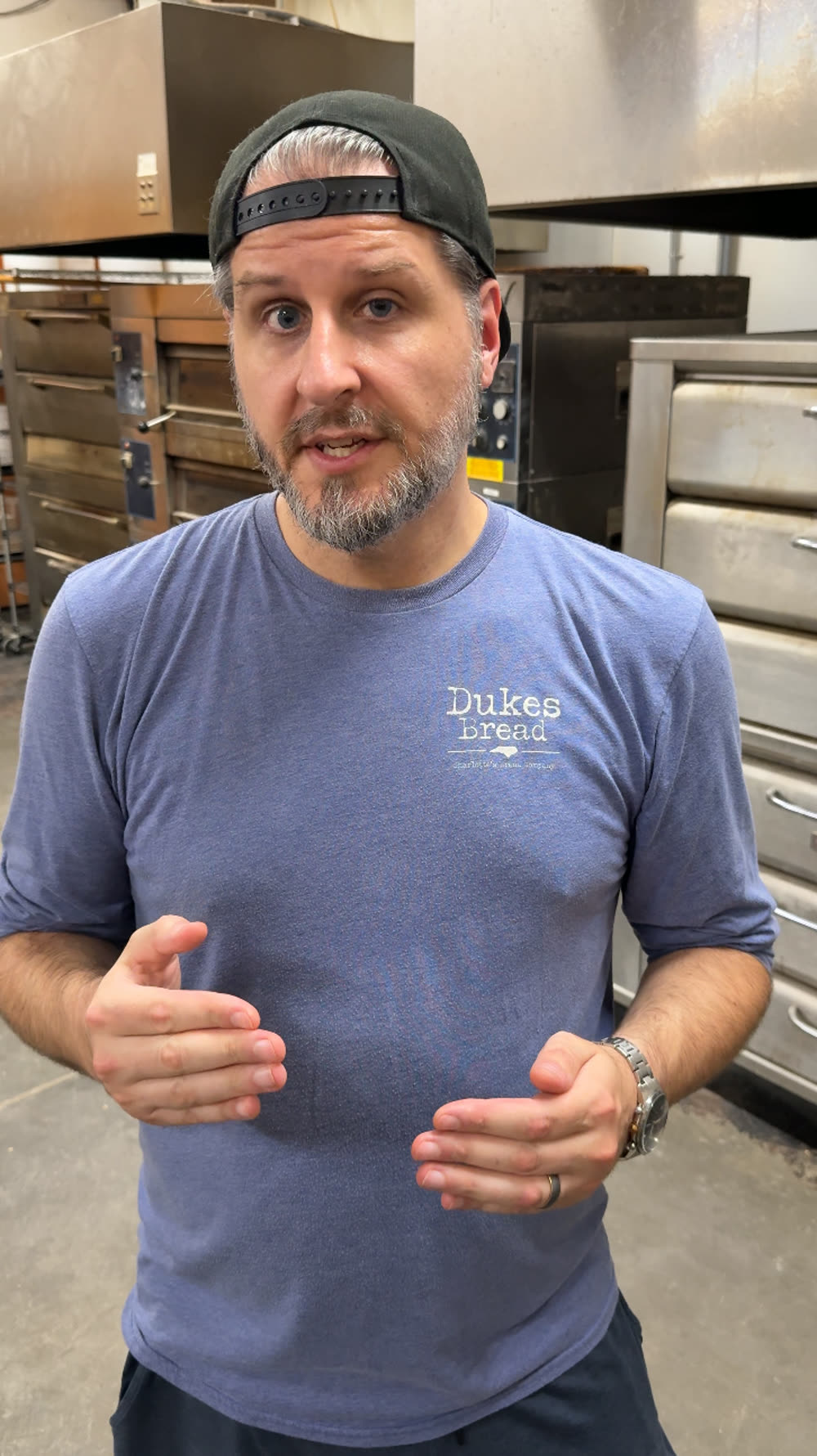 Adam Duke in his commercial bakery in Charlotte, in front of the deck ovens